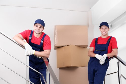 Professional movers carrying items in a Bermondsey street